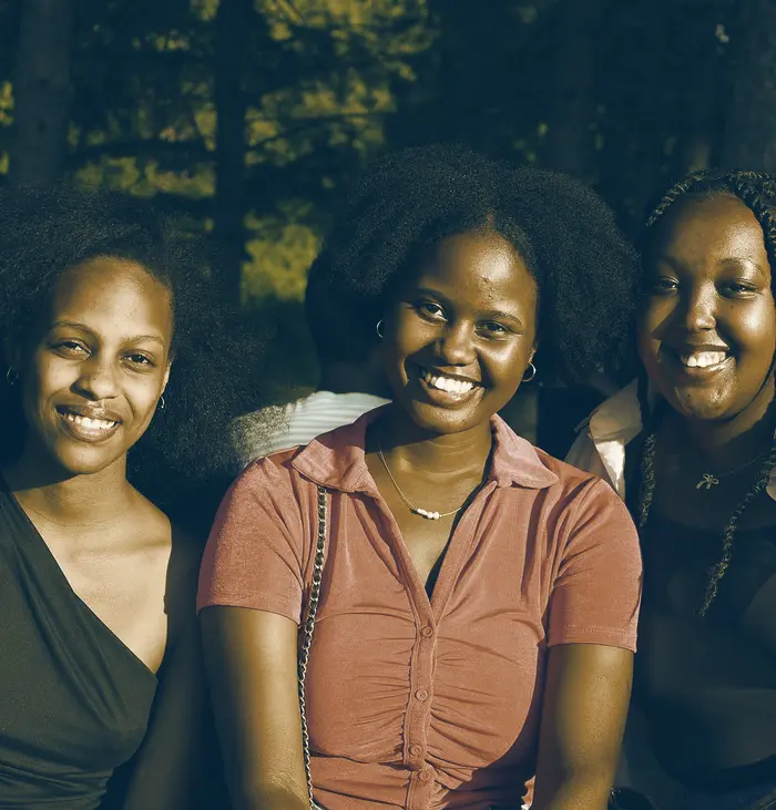Three friends smiling together